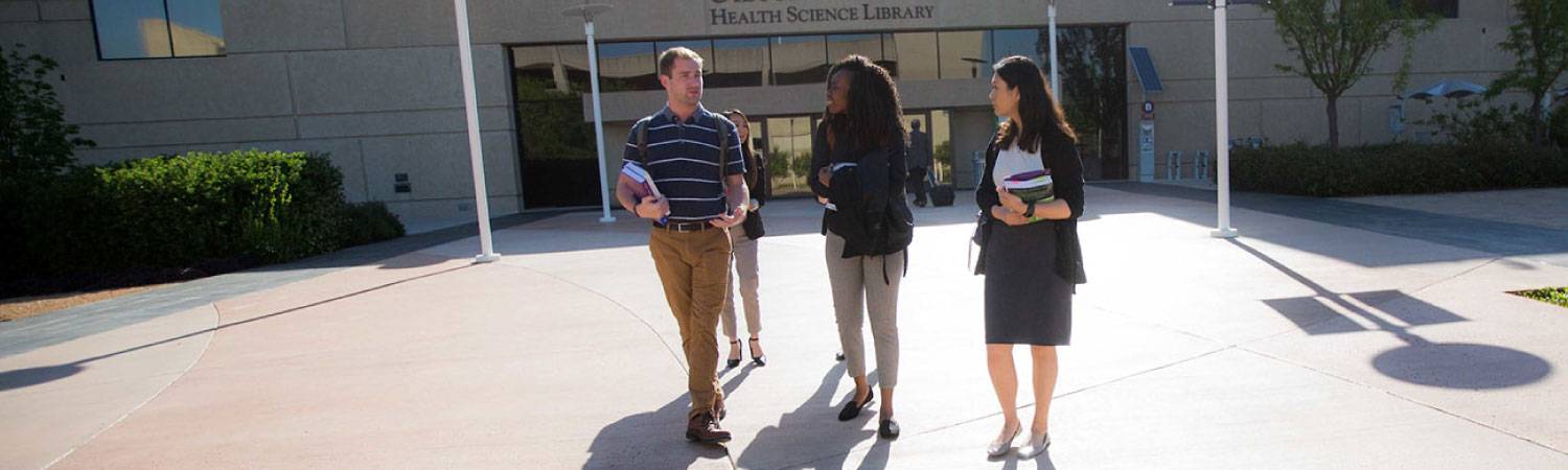 Students walking in front of the library