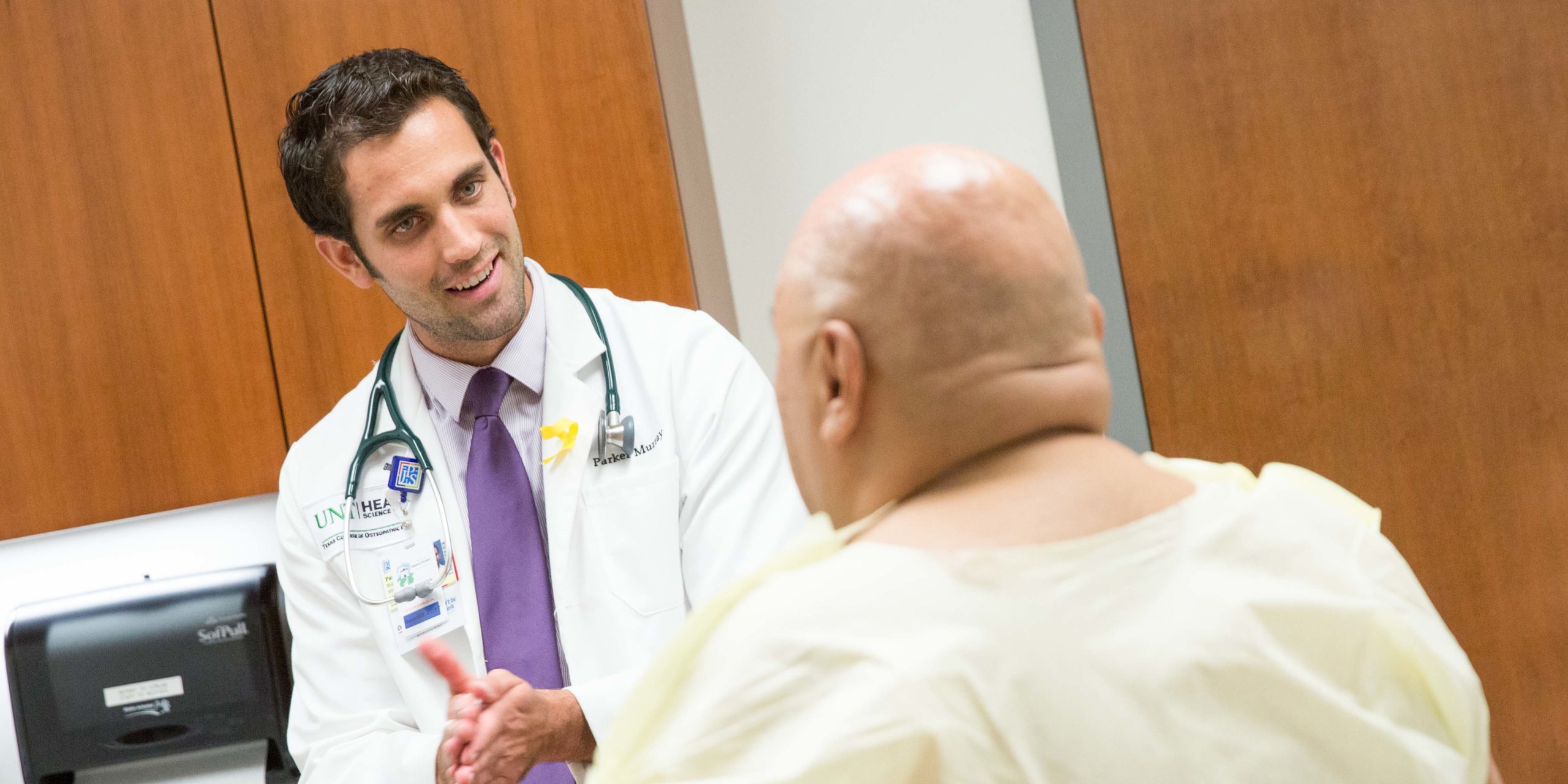 Resident speaking with an older adult patient