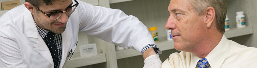 pharmacy student giving a shot