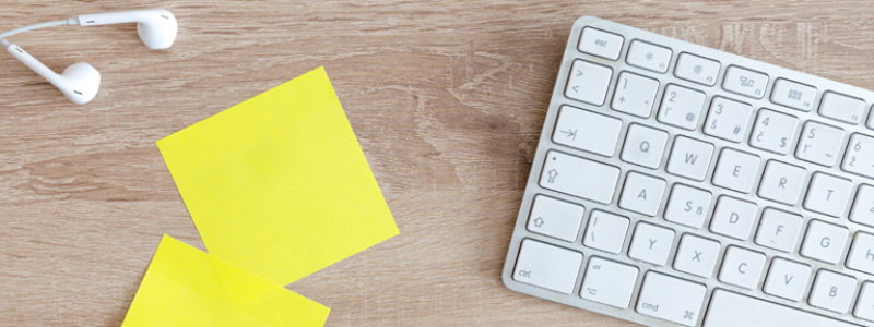 earbuds, post-it notes, and a keyboard