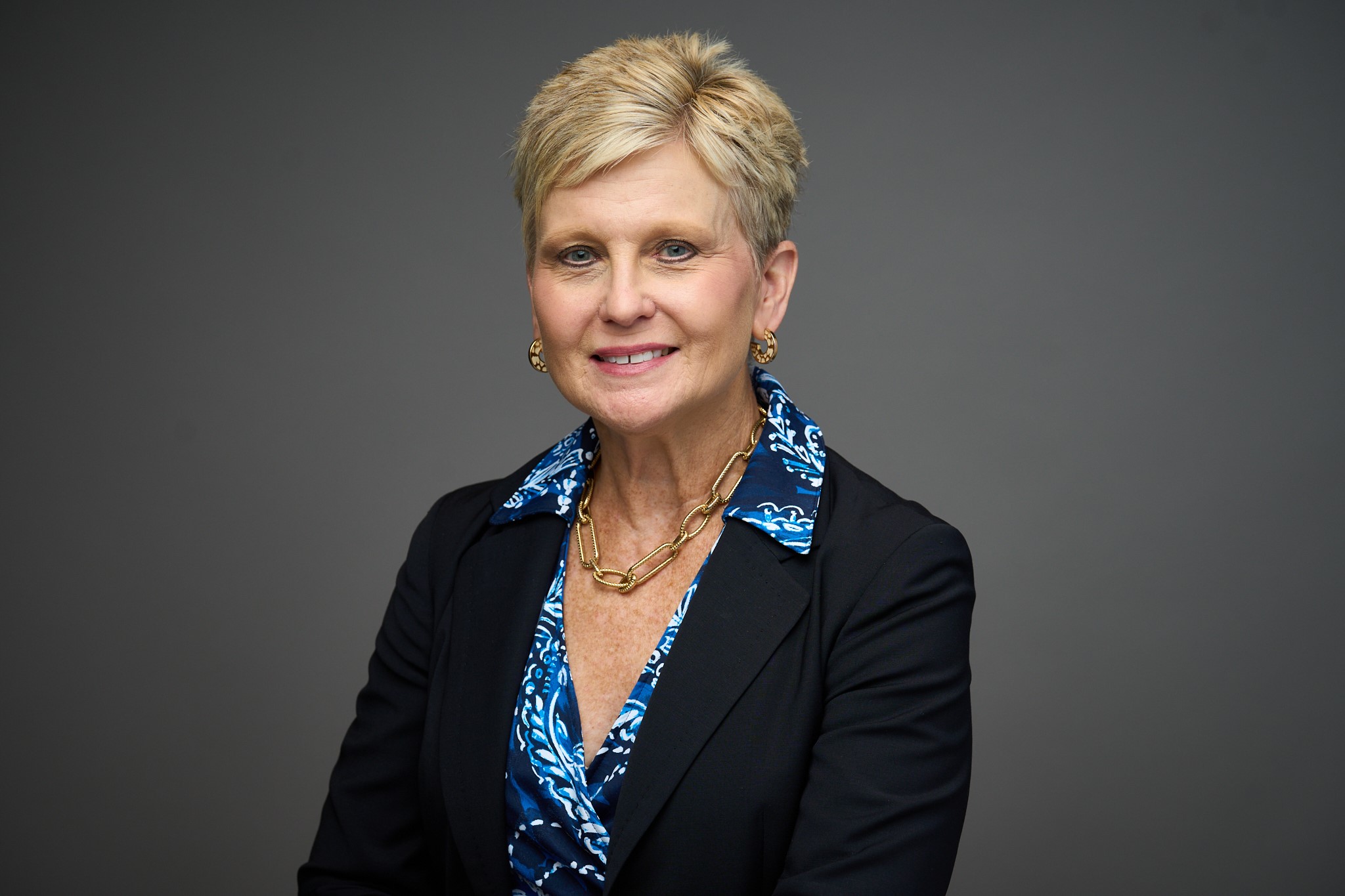 Robyn Remotigue headshot with a gray background