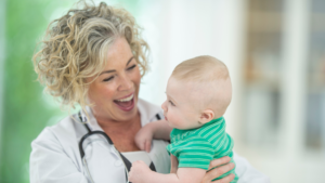 Pediatrician holding baby