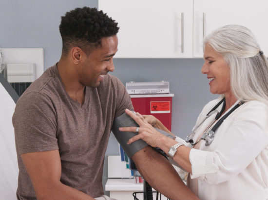 Doctor working with patient while smiling