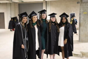 Group of students posing for a photo with their cap and gown on