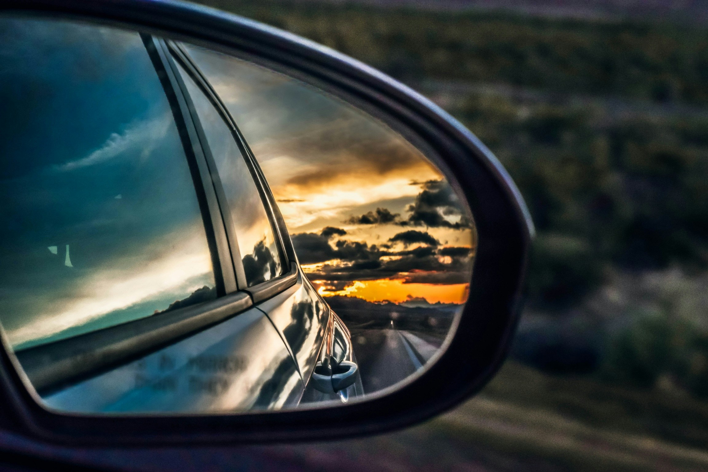 View of sunset in the rearview mirror of a car, by Jake Weirick, Unsplash