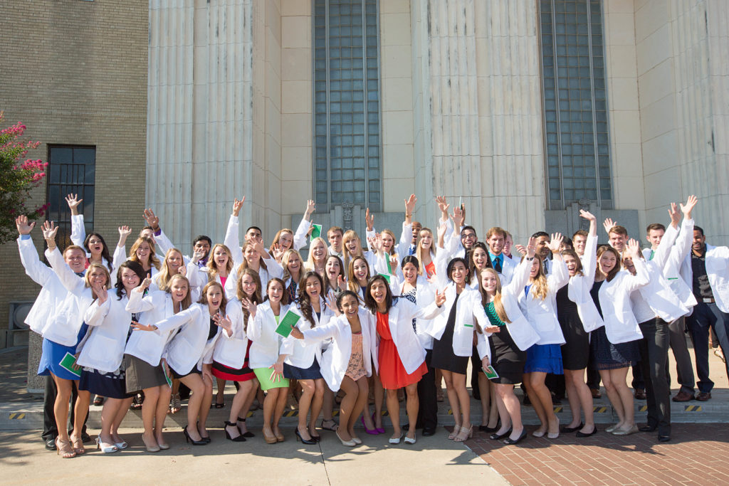 Large group of students in their white coats